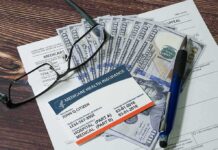 Surprise Medicare Payout Hits Next Week Medicare card on paperwork with cash, glasses, and a pen