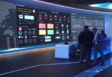 Marines Strike Back: Pentagon Data Nightmare cybersecurity operations room with large data dashboards and people discussing
