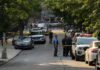 Young Dad Vanishes After Browns Game Police officers secure a residential street with patrol cars and yellow tape