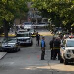 Young Dad Vanishes After Browns Game Police officers secure a residential street with patrol cars and yellow tape
