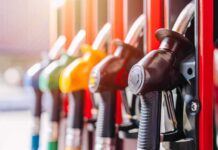 Inflation Jumps – Pump Prices Blamed Close-up of fuel pump nozzles at a gas station
