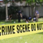 crime scene tape cordoning off a grassy area