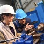 OSHA Bombshell Hits China-Linked Factory Two workers operating a metal lathe in a workshop