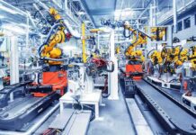 Bill Gates’ Robot Tax Bombshell Industrial robots assembling parts on an automated factory line