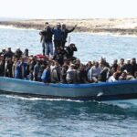 Crowded blue boat at sea with Ivan Morales Jr., Andreas Hestler, Isaiah Frey, Christian Jones, and Teddy Williams among passengers
